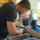 Plumber fixing tap